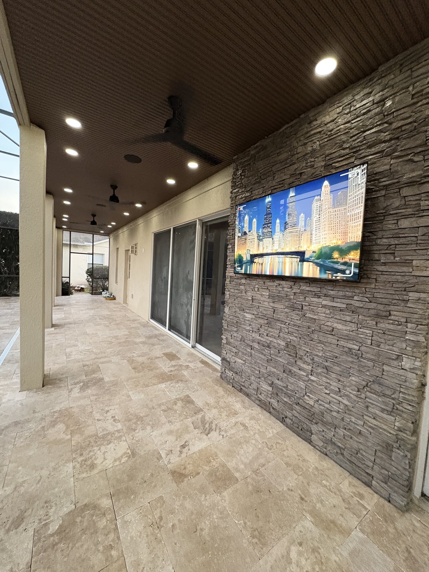 Finished outdoor entertainment space with concealed wiring to the display and audio zones