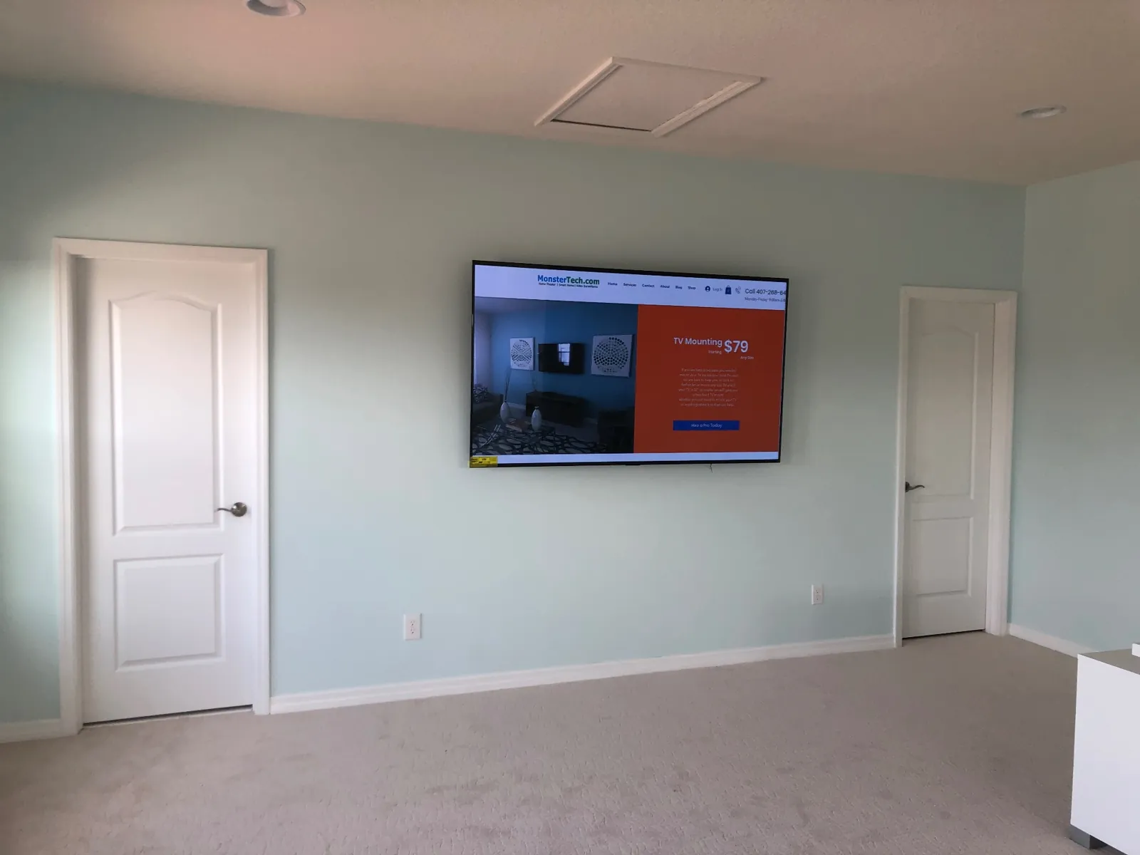 Large flat screen television professionally wall mounted with concealed cabling in a Central Florida home by MonsterTech.com