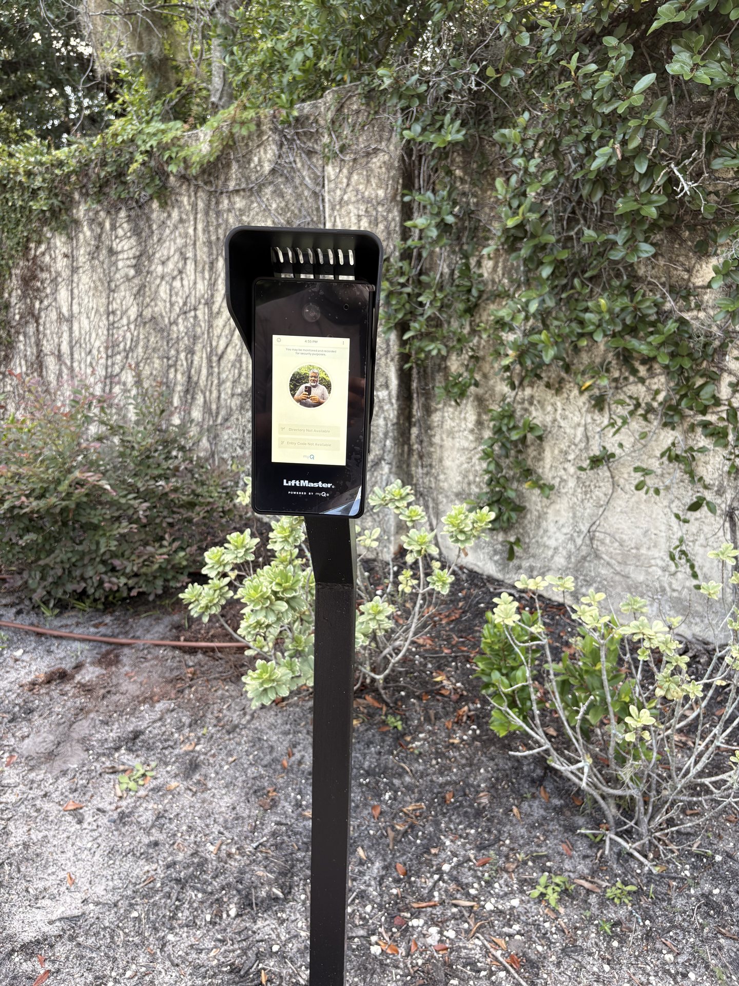 Pedestal-mounted smart video intercom installed at a residential driveway gate entry in ChampionsGate