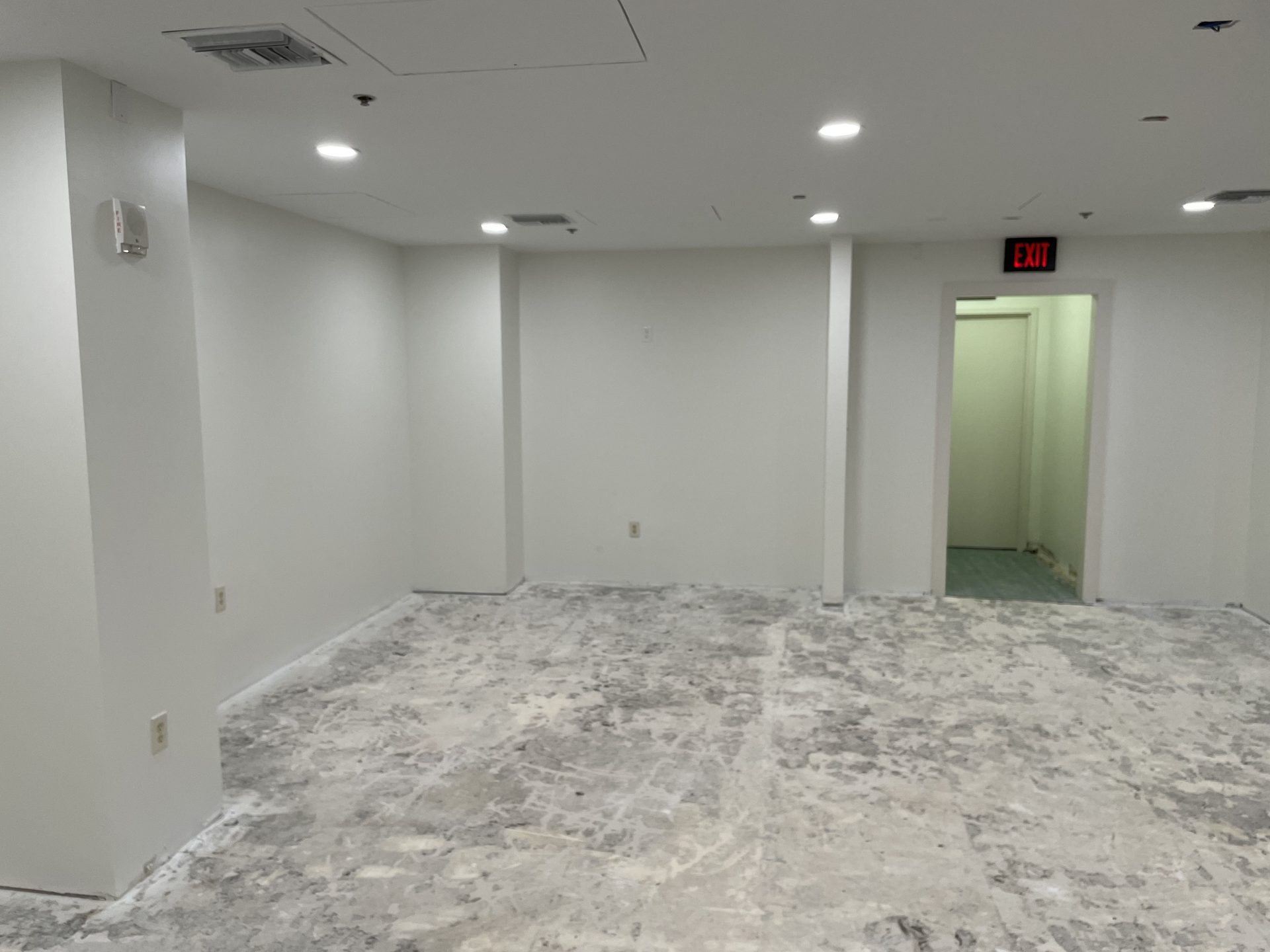 Lobby space during build-out showing concealed AV cabling paths and lighting layout