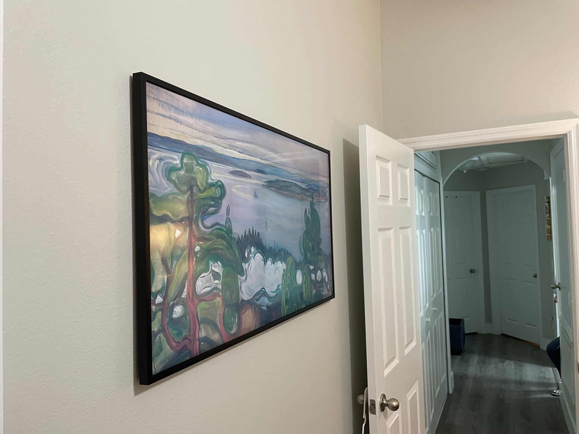 Art-style Frame TV installation viewed from the hallway showing a clean wall with no visible cables