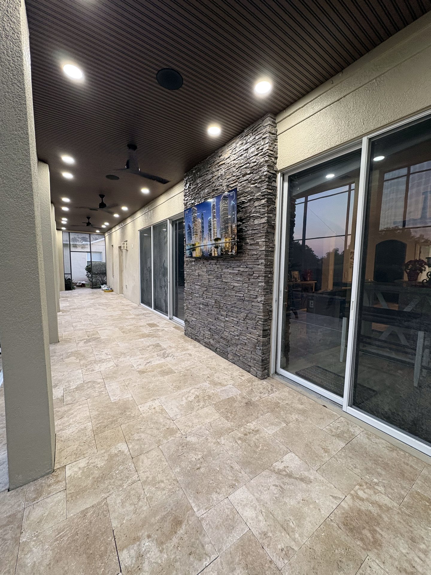 Covered outdoor living area in Lake Nona with a weather-rated TV, outdoor audio and smart lighting