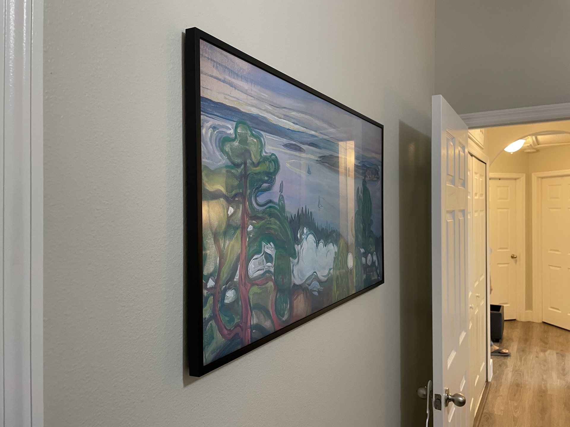 Samsung Frame TV mounted flush to the wall displaying artwork with fully concealed wiring