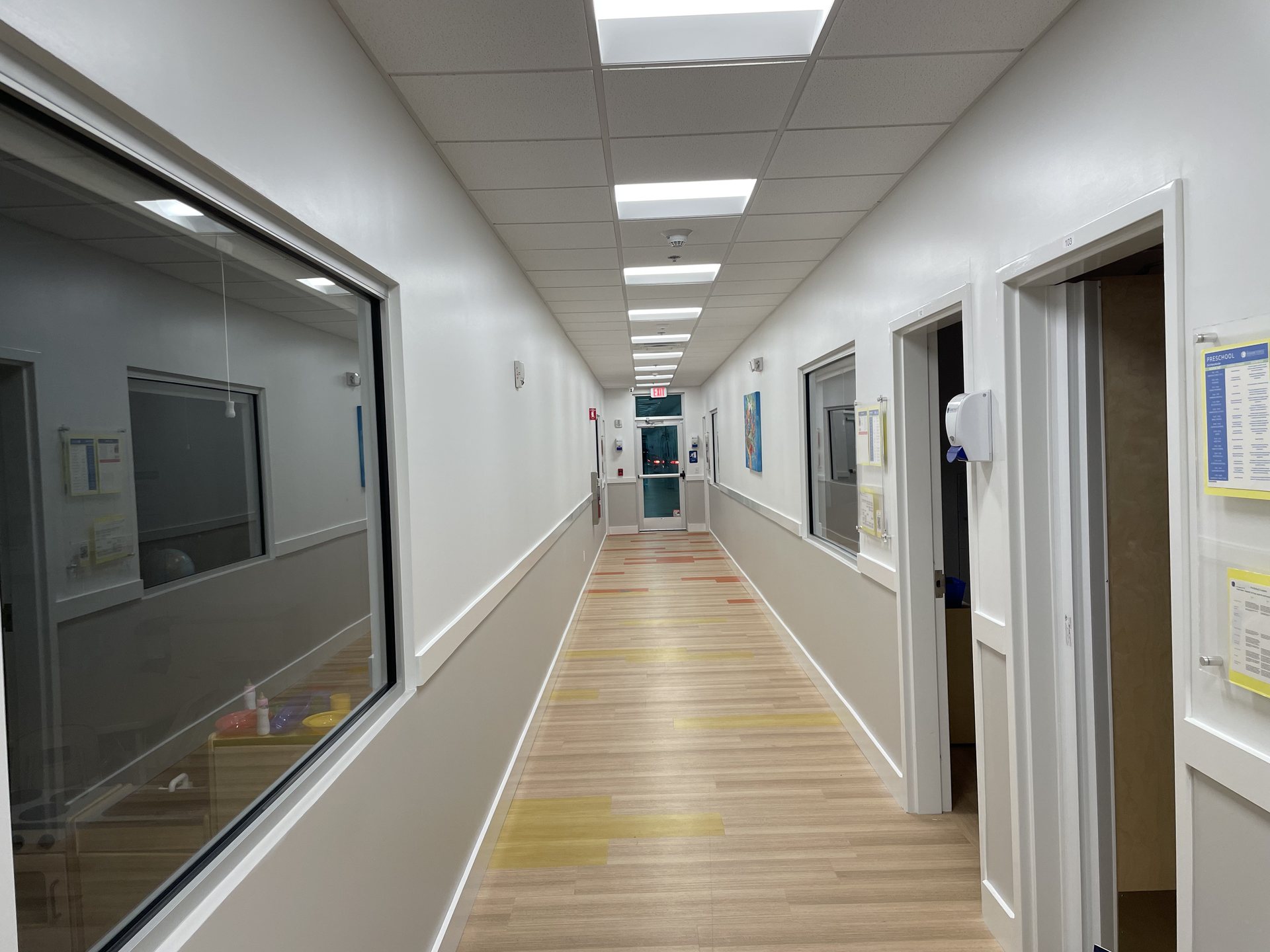 Interior school corridor in Orlando, FL with ceiling-mounted audio and wireless access point coverage