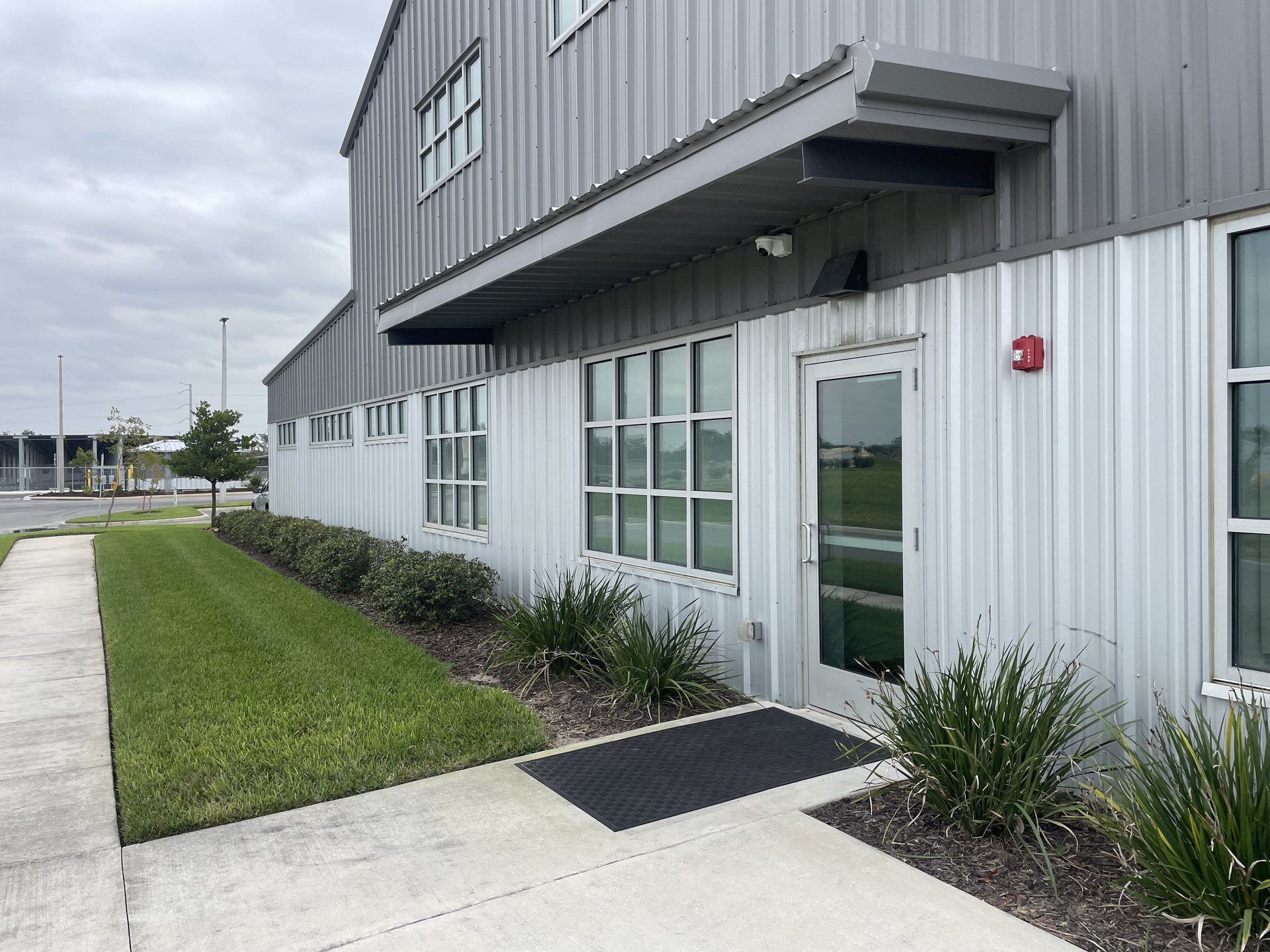 Commercial building exterior in Winter Haven with a security camera mounted under the eave covering a side entry