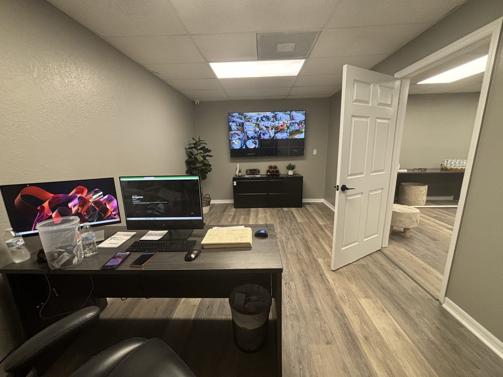 Office workstation with a multi-camera security monitoring display at a commercial property
