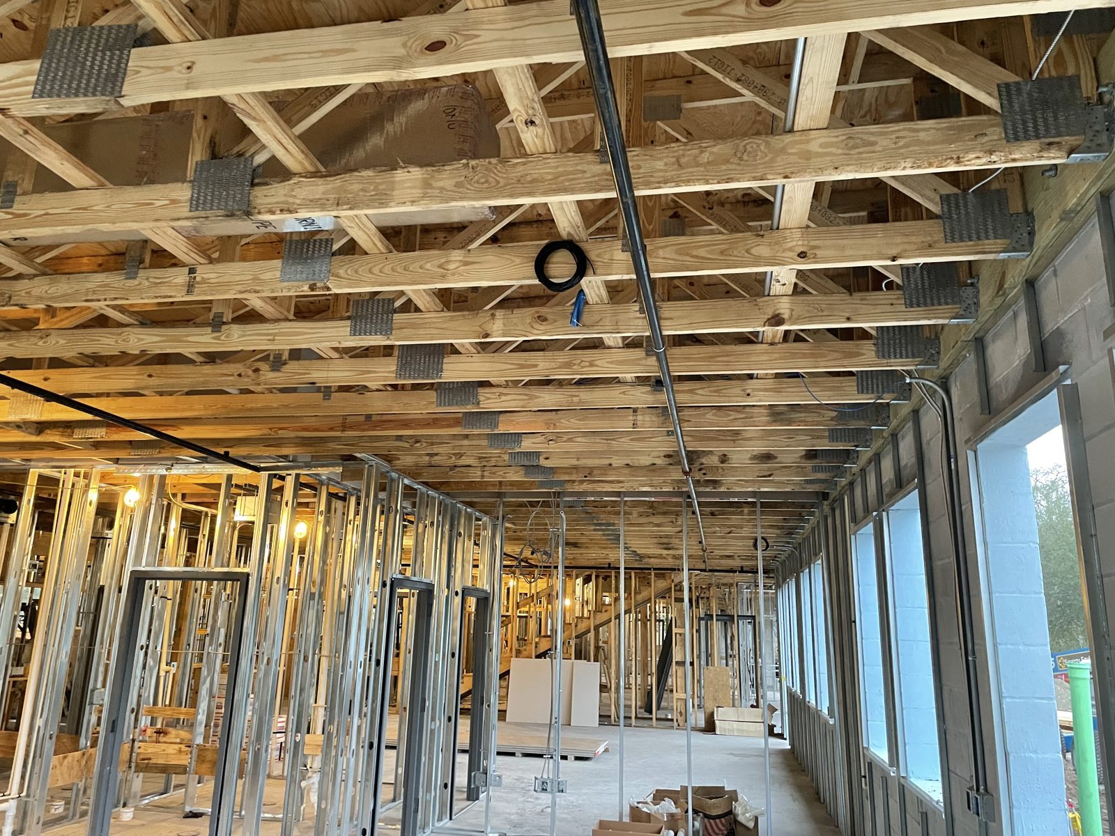 Low-voltage cable rough-in through framing during commercial construction in Central Florida