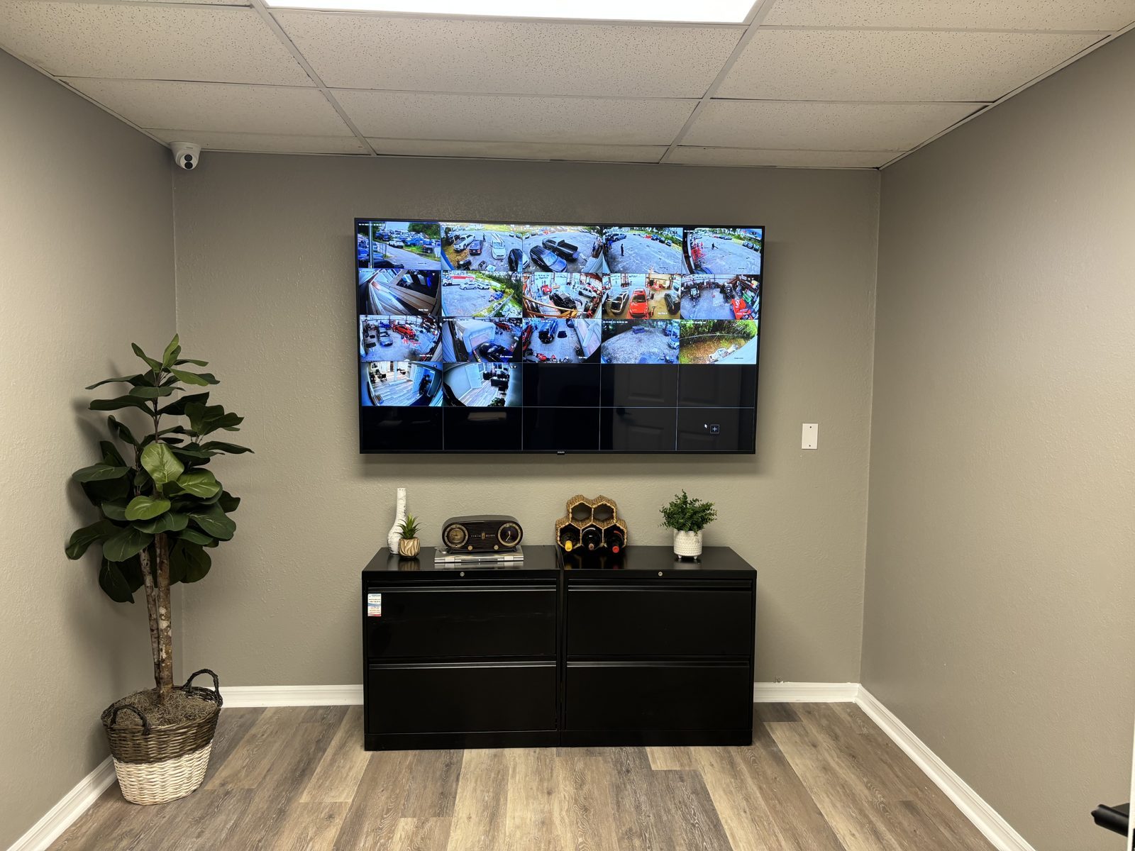 Multi-camera surveillance display mounted on a wall inside an Orlando business